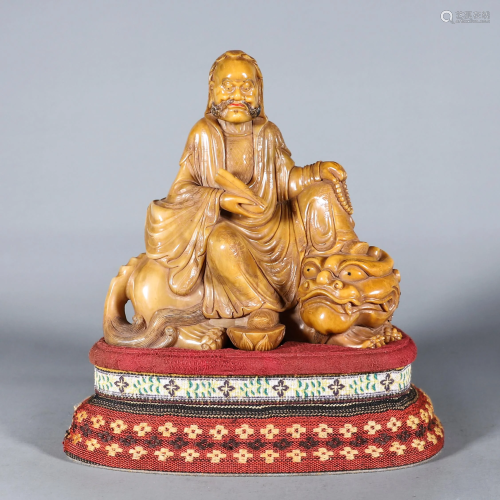 A Carved Tianhuang Arhat with Buddhist Lion