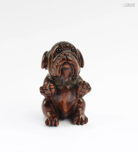 A Carved Wooden Dog Figurine