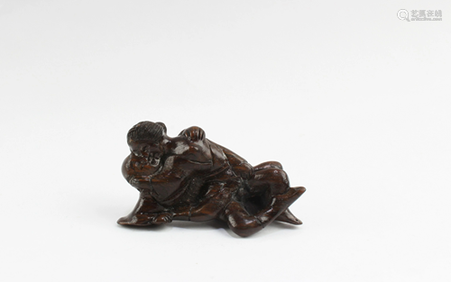 A Carved Wooden Two Persons Figurine