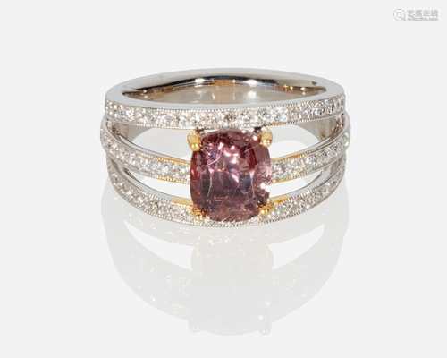 A purplish-pink sapphire and diamond ring