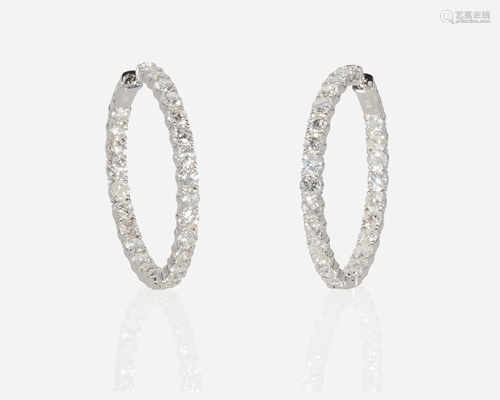 A pair of diamond hoop earrings