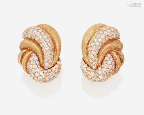 A pair of diamond swirl ear clips