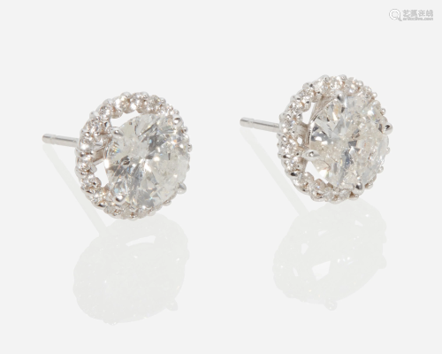 A pair of diamond halo stud earrings