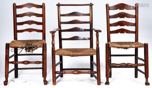 Three elm ladder back chairs, including an elbow chair, all ...