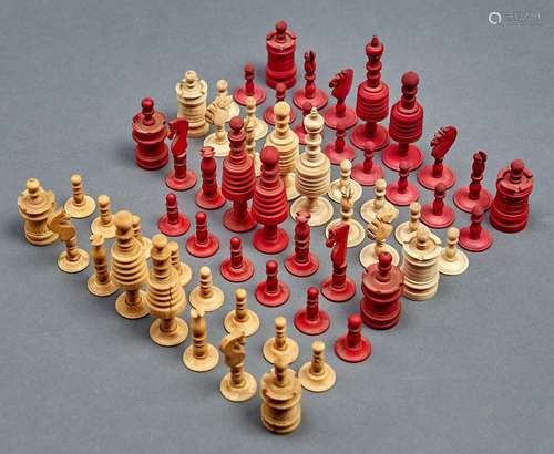 A Victorian red stained bone chess set, kings 10cm h, anothe...