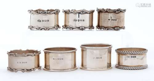 Seven Edwardian and later silver napkin rings, including a p...