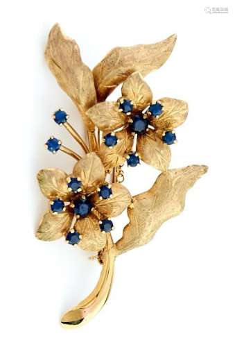 A sapphire spray brooch in 9ct gold, with textured petals an...
