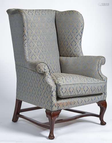 A mahogany stained wing back armchair in George III style, m...