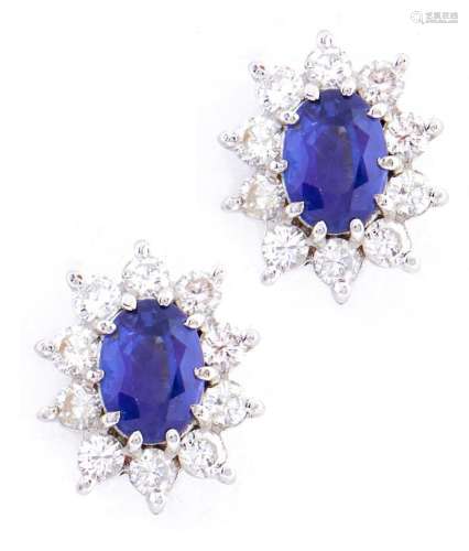 A pair of sapphire and diamond cluster earrings, the larger ...