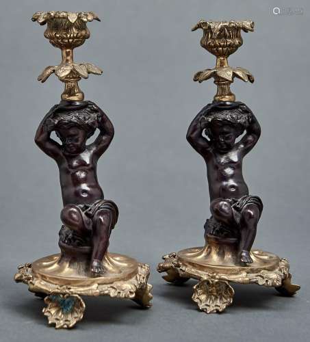 A pair of figural bronze candlesticks, 20th c, in French mid...