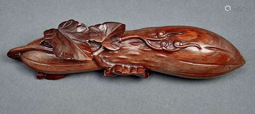 A Chinese carved hardwood box and cover in the form of a gou...