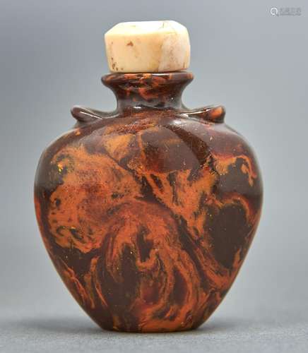 A Chinese amber snuff bottle, 20th c, with vestigial shoulde...