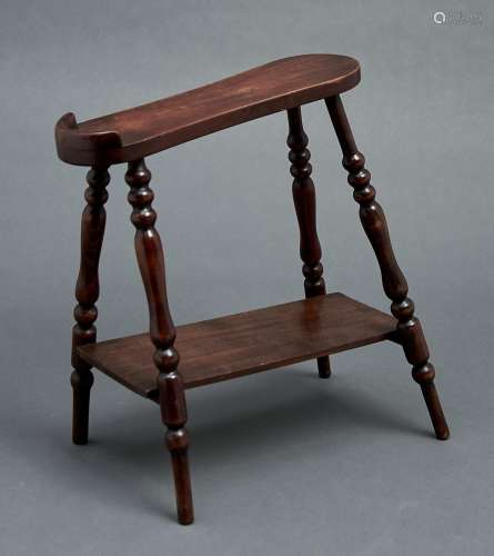 A mahogany-stained wood foot rest, early 20th c, on four sli...