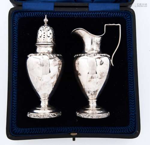 A George V silver sugar caster and cover and matching cream ...