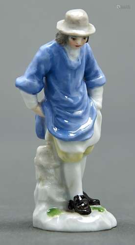 A Meissen miniature figure of a man in a lavender coloured s...