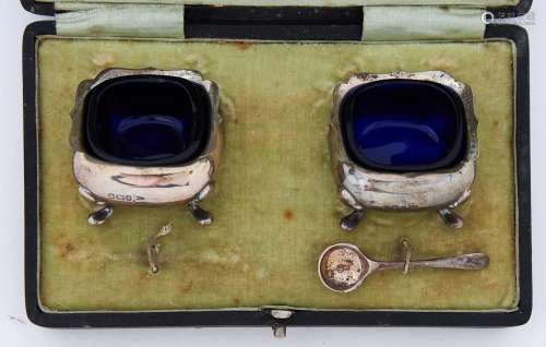 A pair of George V shaped square silver salt cellars, blue g...