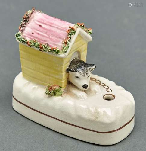 A Staffordshire pottery dog in a kennel inkwell, reproductio...