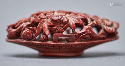 A Chinese peach stone carving of a basket of flowers, 19th c...