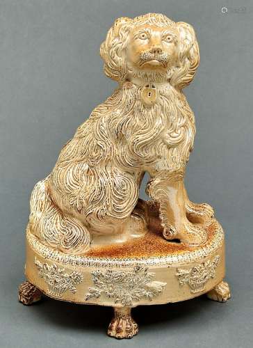 A Derbyshire saltglazed brown stoneware model of a spaniel, ...