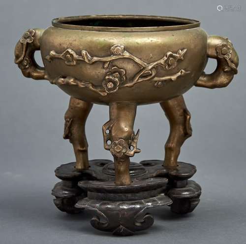 A Chinese bronze tripod censer, 19th c, cast with prunus, 17...
