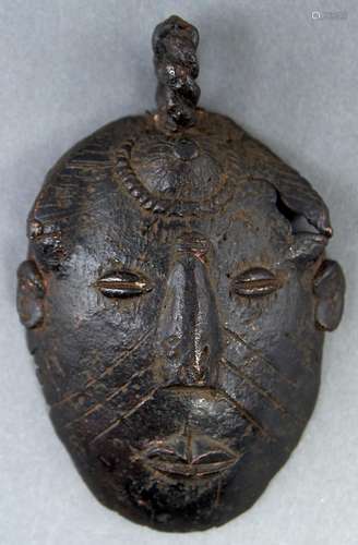 Tribal art. An African bronze face form ceremonial ladle, po...