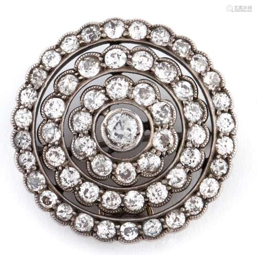A diamond brooch-pendant of concentric circular design with ...