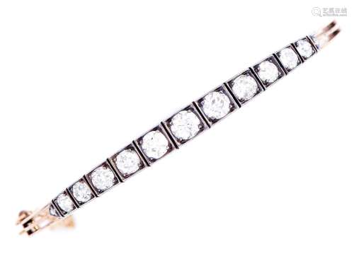 An Edwardian diamond bangle, c1910, with graduated line of e...
