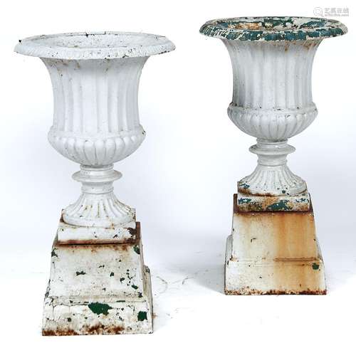 A pair of campana shaped garden vases on stepped square base...