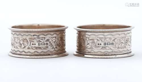 A pair of Edwardian silver napkin rings, engraved with a ban...