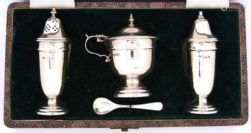 A George VI three piece silver vase shaped condiment set, bl...