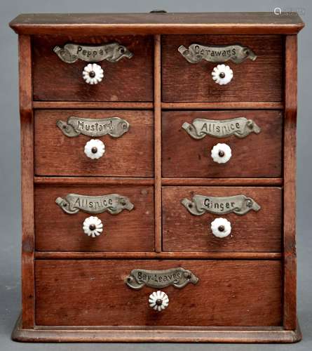Kitchenalia. A light wood spice cabinet, early 20th c, of se...