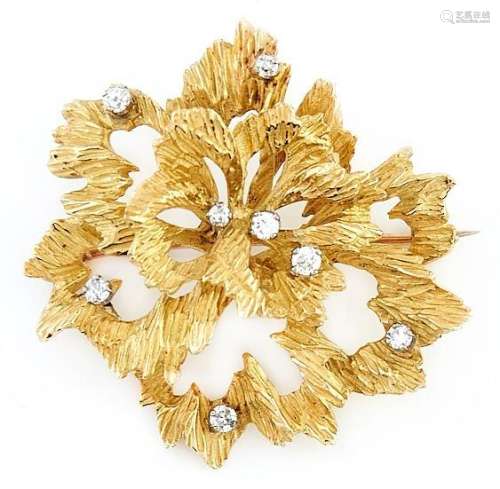 A diamond brooch of cast textured 18ct gold openwork abstrac...