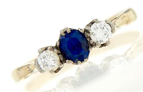 A sapphire and diamond ring, the cushion shaped sapphire fla...