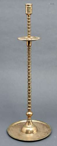 An Islamic brass candlestick, 18th / 19th c, the moulded sco...
