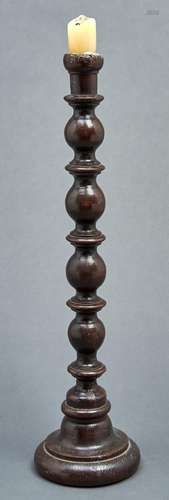 A turned oak candlestick, part 18th c, on domed foot, 51cm h...