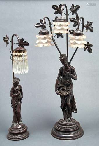 Two reproduction resin lamps, each with standing female figu...