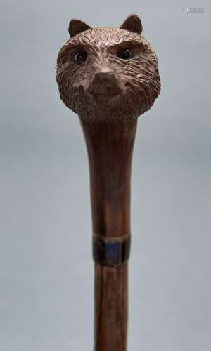 A briar wood walking cane with swiss carved wood bear's head...