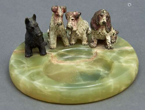 An onyx ashtray, c1930, mounted with four cold painted bronz...