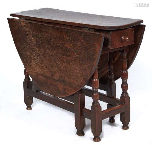 An oak gateleg table, late 17th c, the oval top above single...