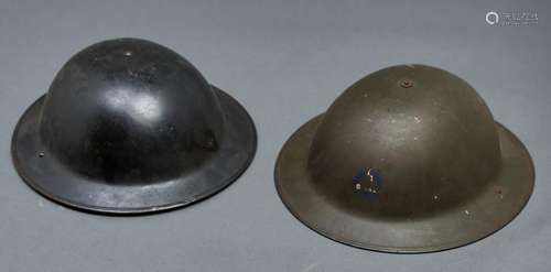 Two World War II steel helmets, both with suspension webbing...