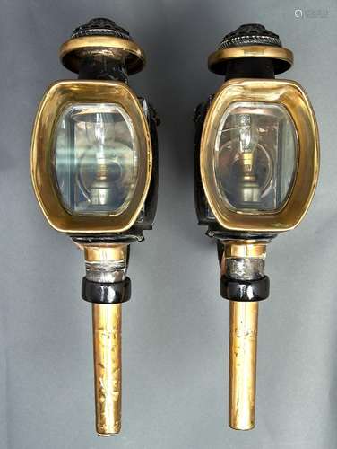 A pair of Victorian black japanned and brass carriage lamps,...