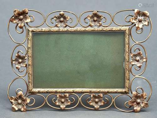A stamped brass and wirework photograph frame, c1910, with f...