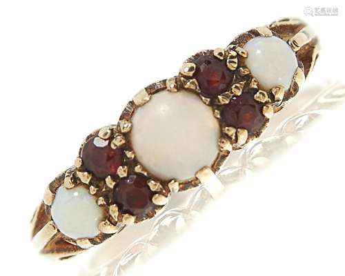 An opal and garnet ring, in 9ct gold, London 1971, 3.4g, siz...
