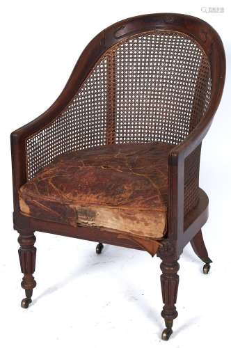 A George IV mahogany and caned bergere, c1830, the reeded fr...