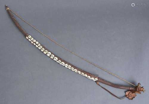 Tribal art. A wood, leather and fibre archer's bow applied w...