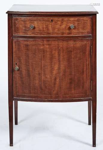 A bow fronted mahogany cupboard, early 20th c, with fiddle b...