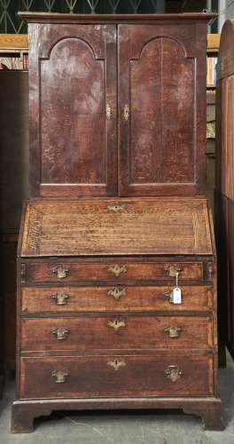 An oak bureau bookcase, late 18th c, the top with flared cav...