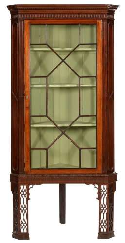 A George III mahogany corner cabinet, late 18th c, with dent...