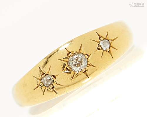 A three stone diamond ring, gypsy set in 18ct gold, London 1...