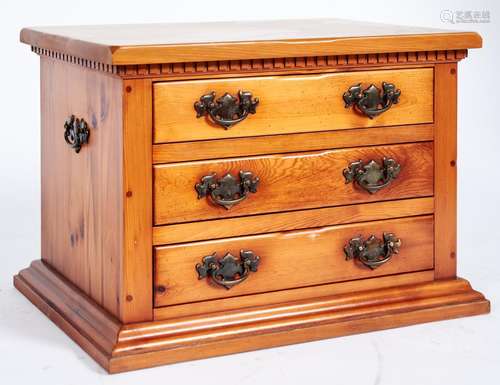 A pine chest of drawers, the rectangular top above a dentil ...